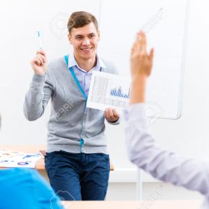 34889194 young teacher man talking with students in the classroom stock photo
